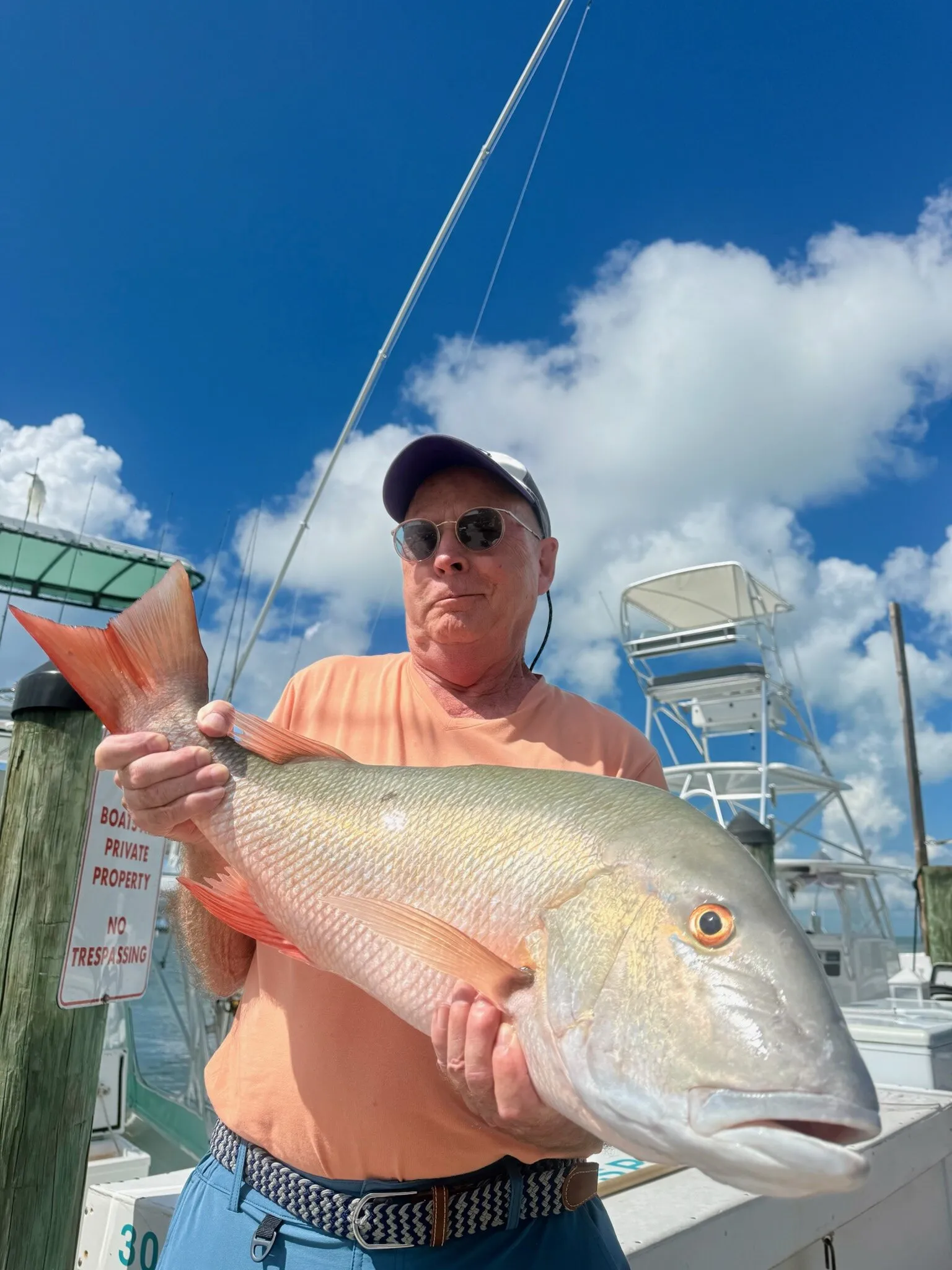 Angler in orange with a mutton snapper