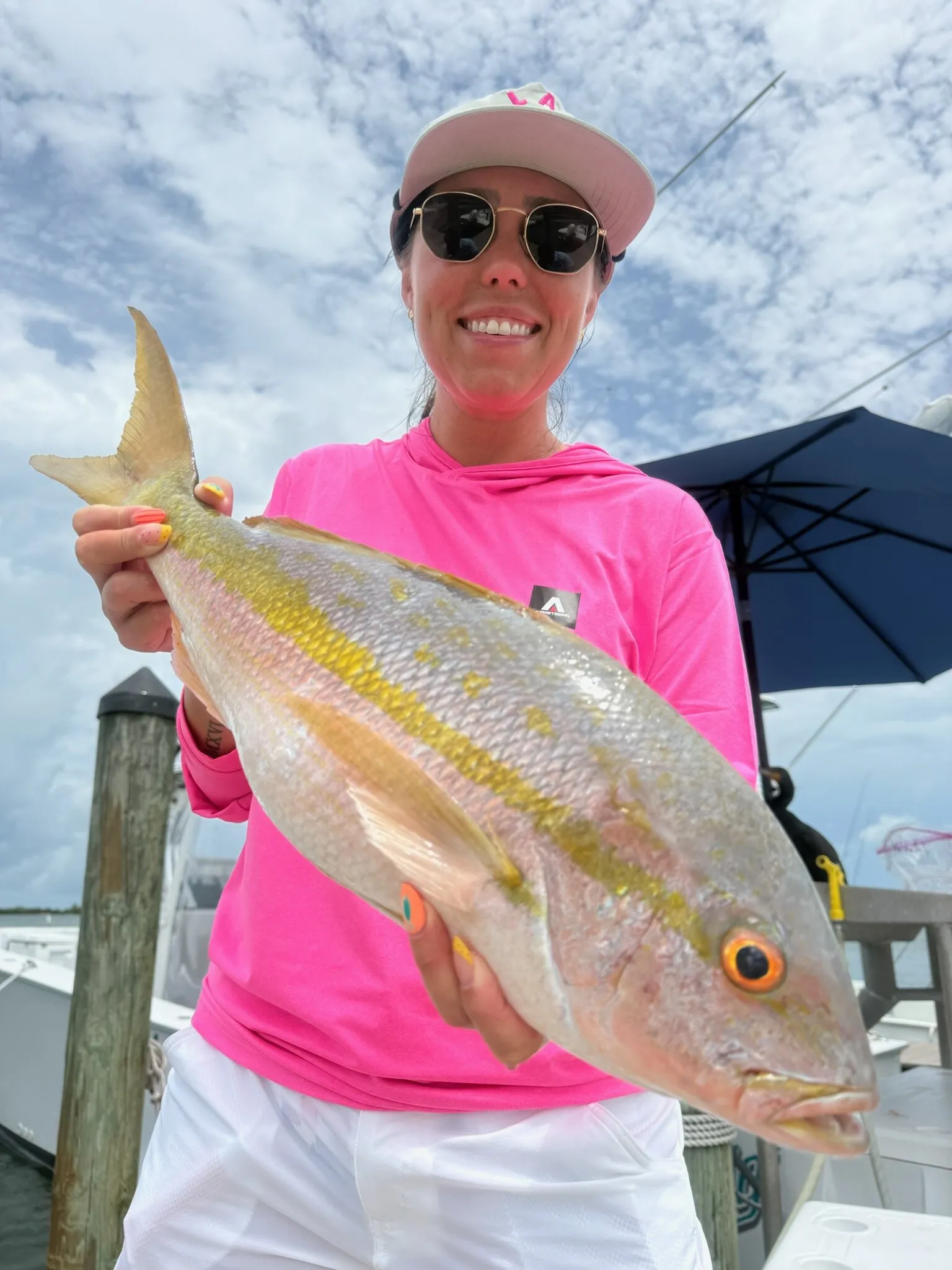 Angler in pink with a yellowtail snapper