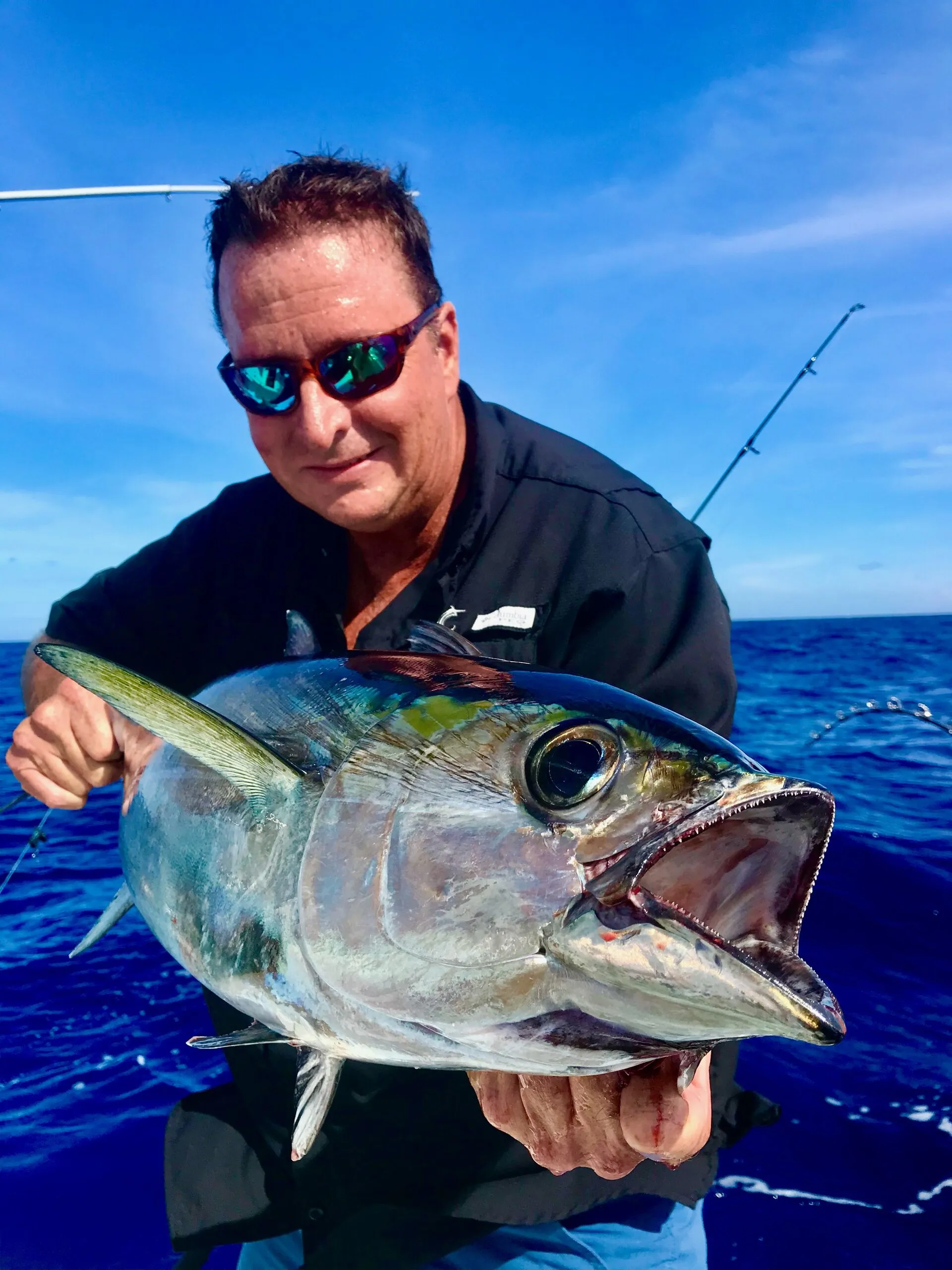 Angler with a blackfin tuna up close