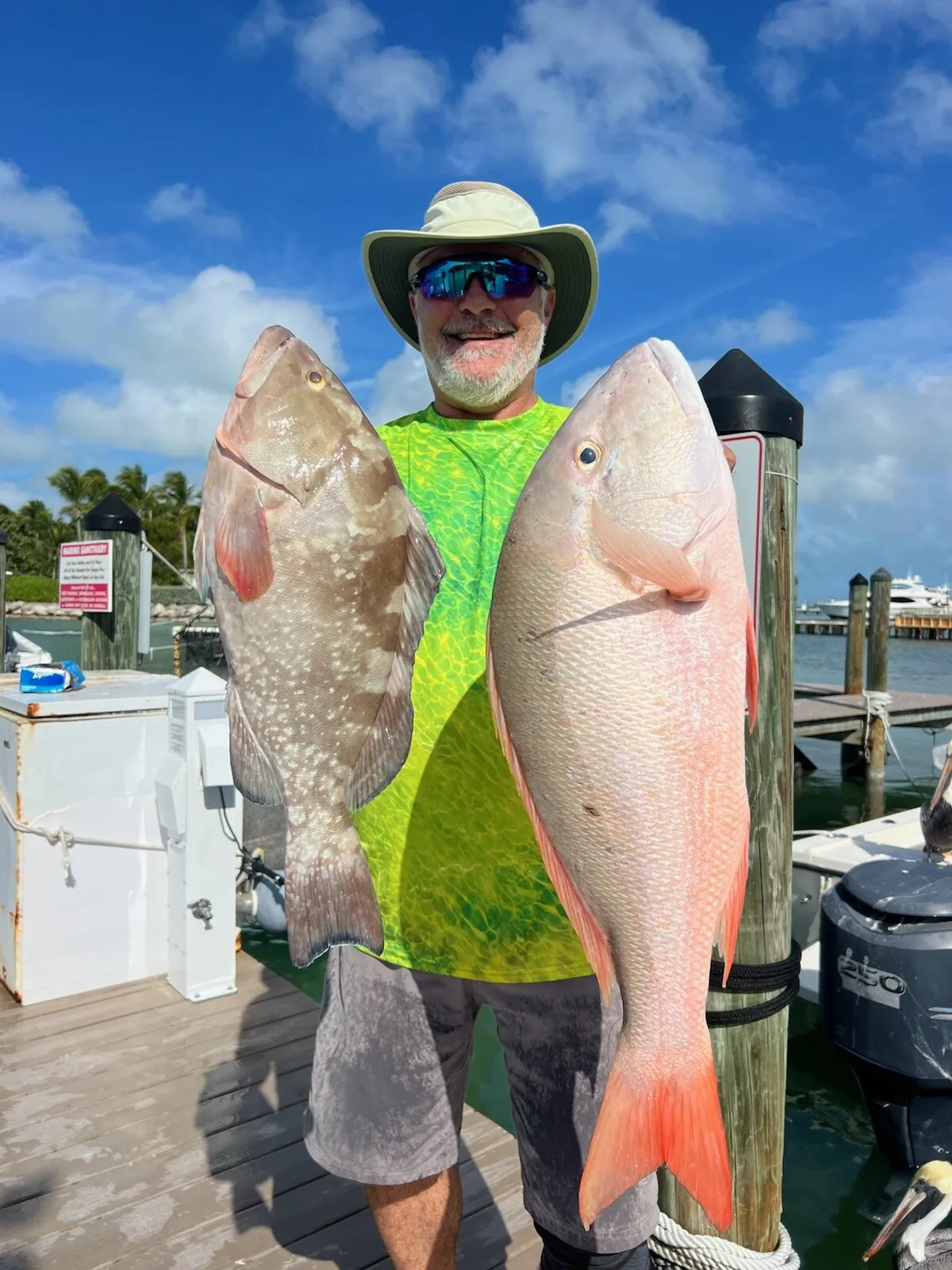 Angler with a grouper and a mutton snapper