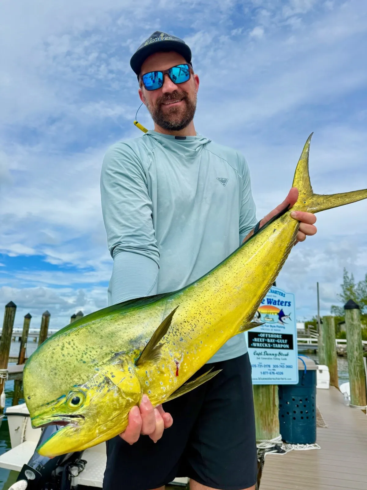 Angler with a mahi on the dock