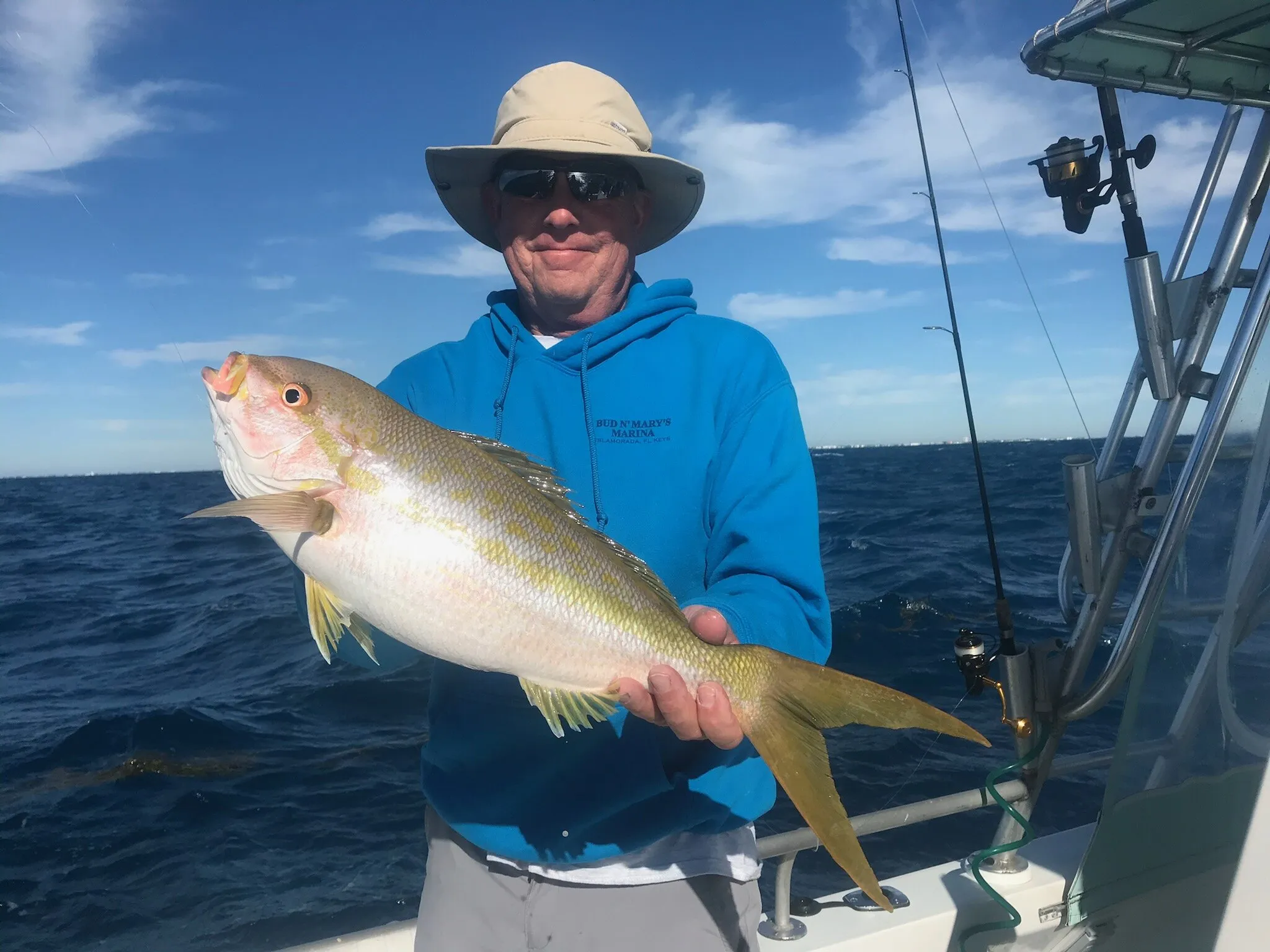 Angler with a yellowtail snapper offshore