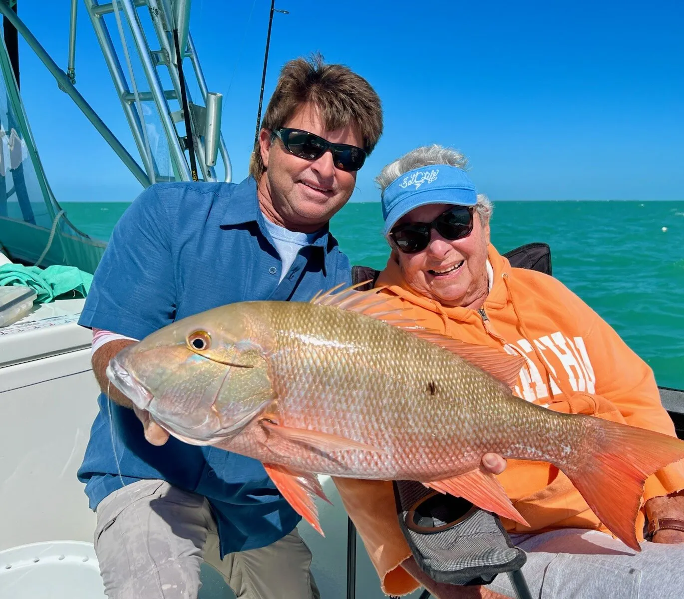 Captain jimmy with a guest and a mutton snapper