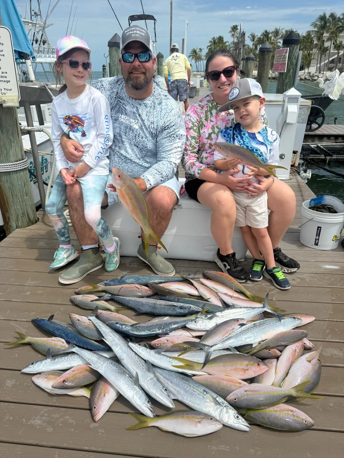 Family with their catch on the dock