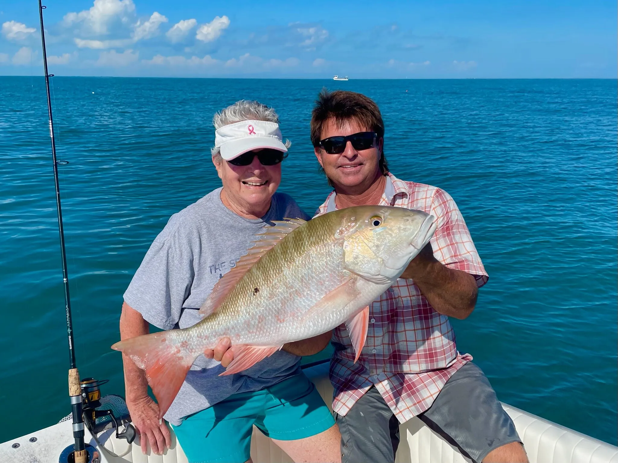 Guests with a mutton snapper offshore