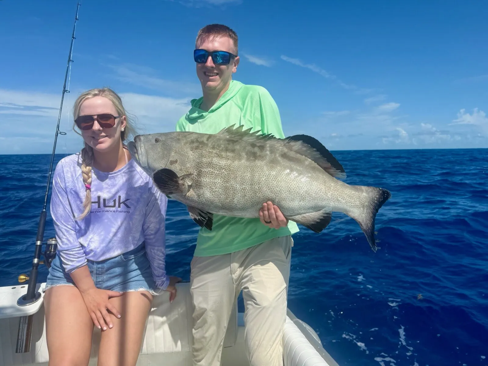 Two anglers with a black grouper offshore