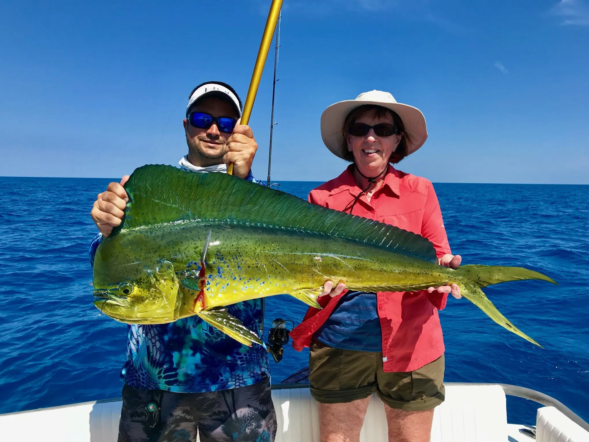 Two anglers with a mahi