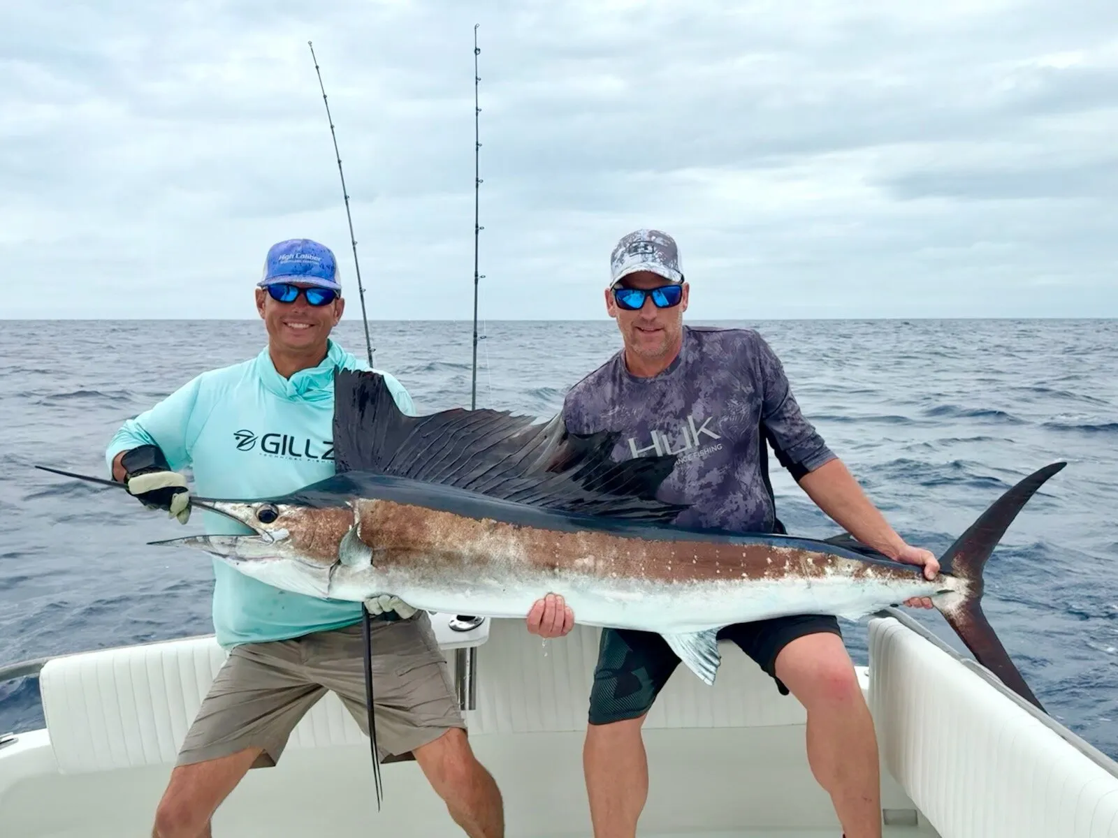 Two anglers with a sailfish in the cockpit