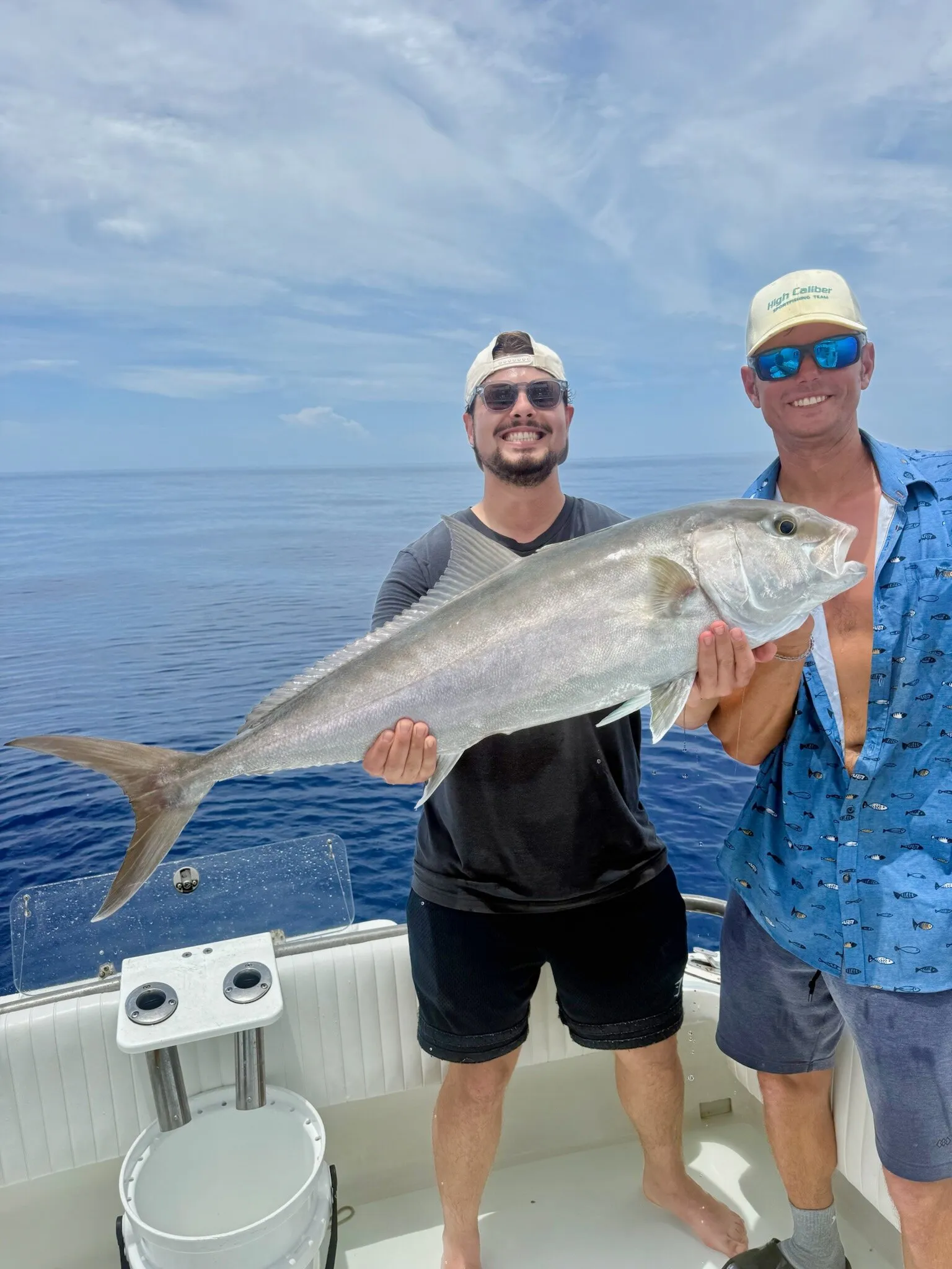 Two anglers with an amberjack